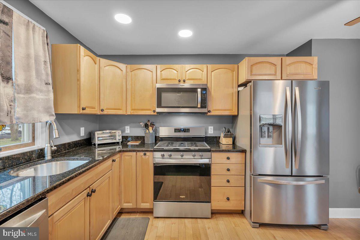 20 West Laurel Road Stratford, NJ 08084 - Photo 11 of 24 a kitchen with stainless steel appliances granite countertop a refrigerator a stove a sink and a microwave