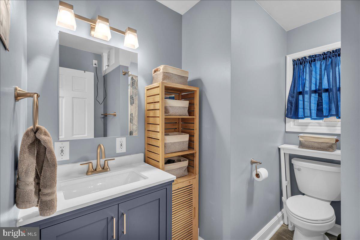 20 West Laurel Road Stratford, NJ 08084 - Photo 12 of 24 a bathroom with a granite countertop toilet sink and mirror