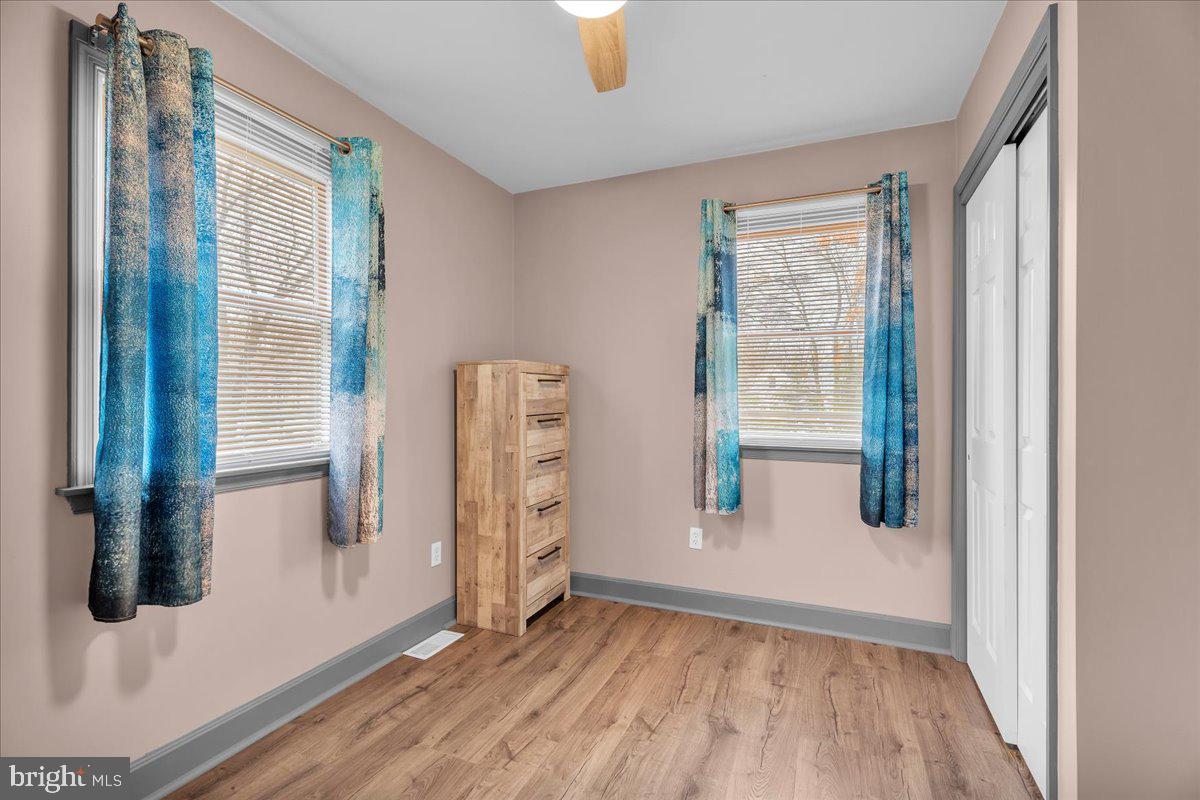 20 West Laurel Road Stratford, NJ 08084 - Photo 15 of 24 wooden floor in an empty room with a window