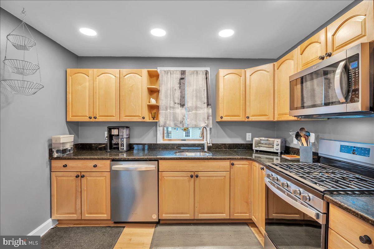 20 West Laurel Road Stratford, NJ 08084 - Photo 10 of 24 a kitchen with granite countertop cabinets stainless steel appliances a sink and a window