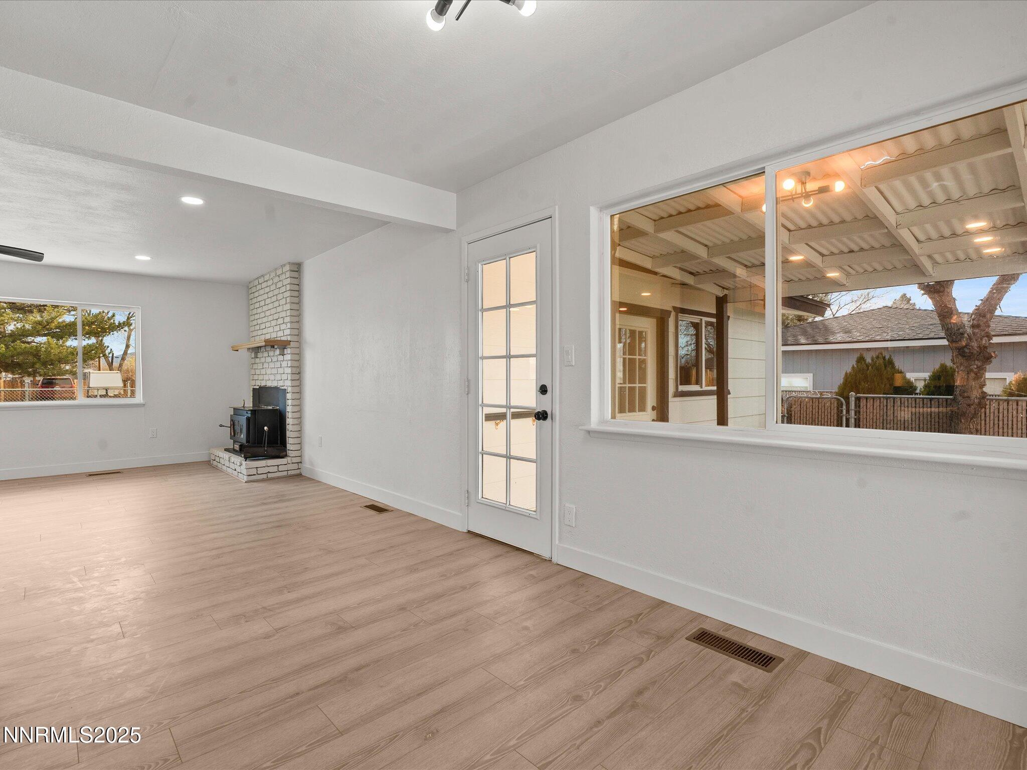 2940 Lukens Lane Carson City, NV 89706 - Photo 13 of 46 a view of an empty room with a window and wooden floor