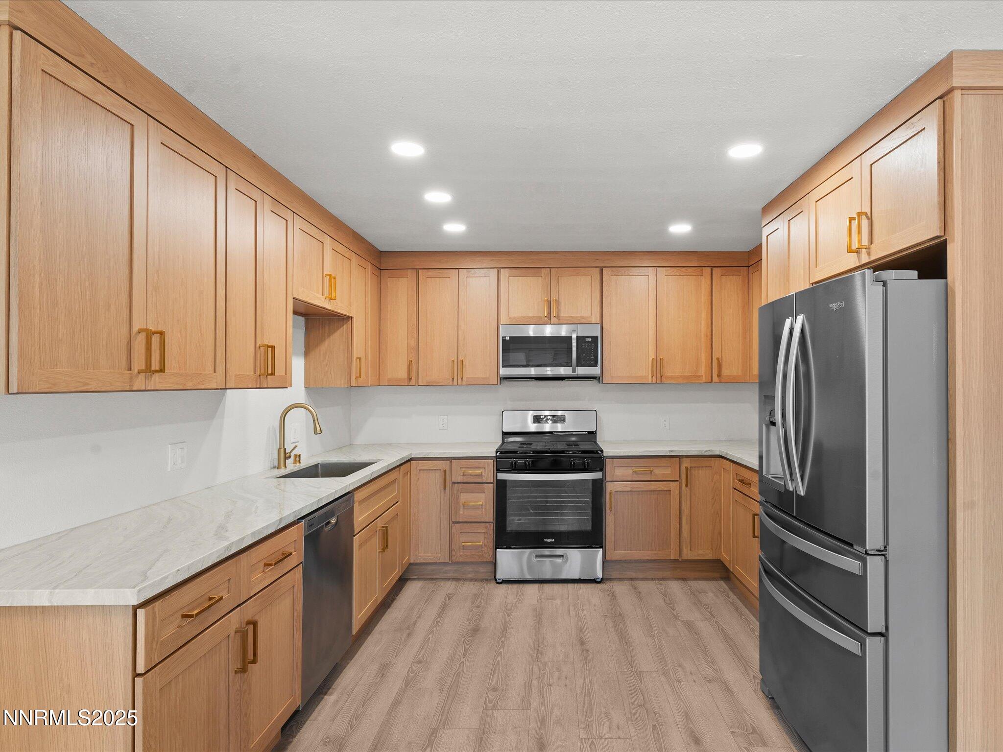 2940 Lukens Lane Carson City, NV 89706 - Photo 14 of 46 a kitchen with stainless steel appliances granite countertop a refrigerator stove microwave and sink
