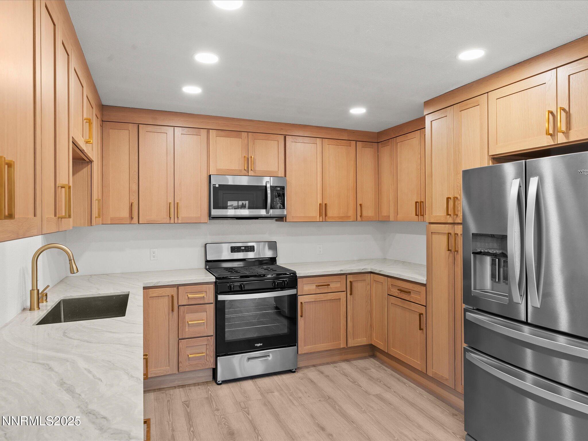 2940 Lukens Lane Carson City, NV 89706 - Photo 16 of 46 a kitchen with granite countertop a sink stainless steel appliances and cabinets