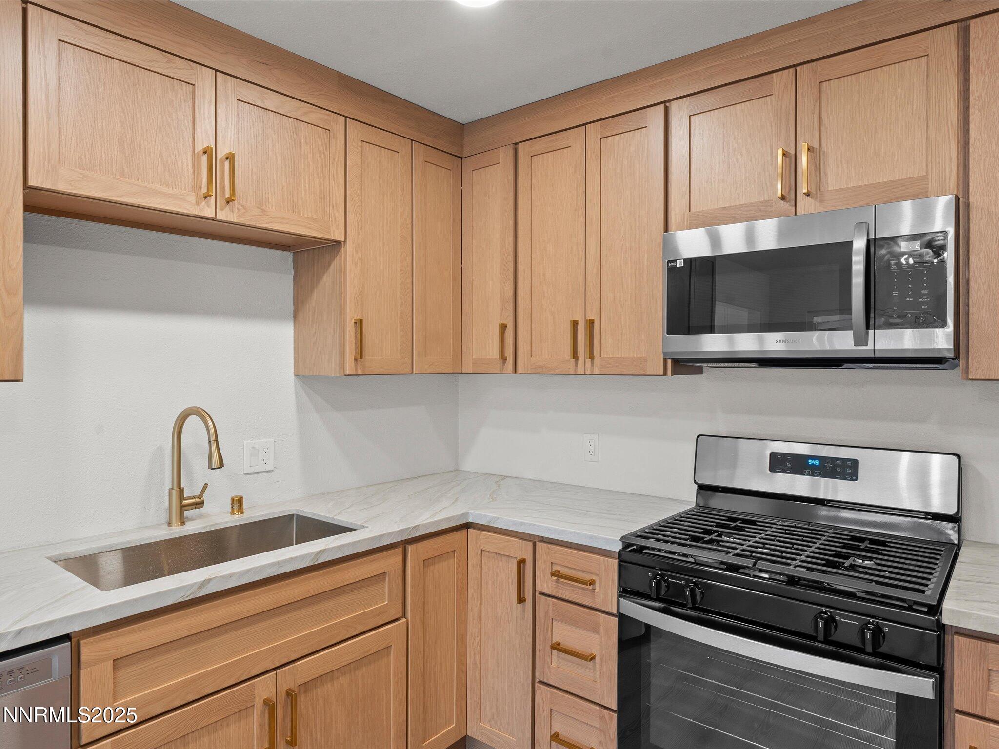 2940 Lukens Lane Carson City, NV 89706 - Photo 18 of 46 a kitchen with stainless steel appliances granite countertop a sink stove and microwave