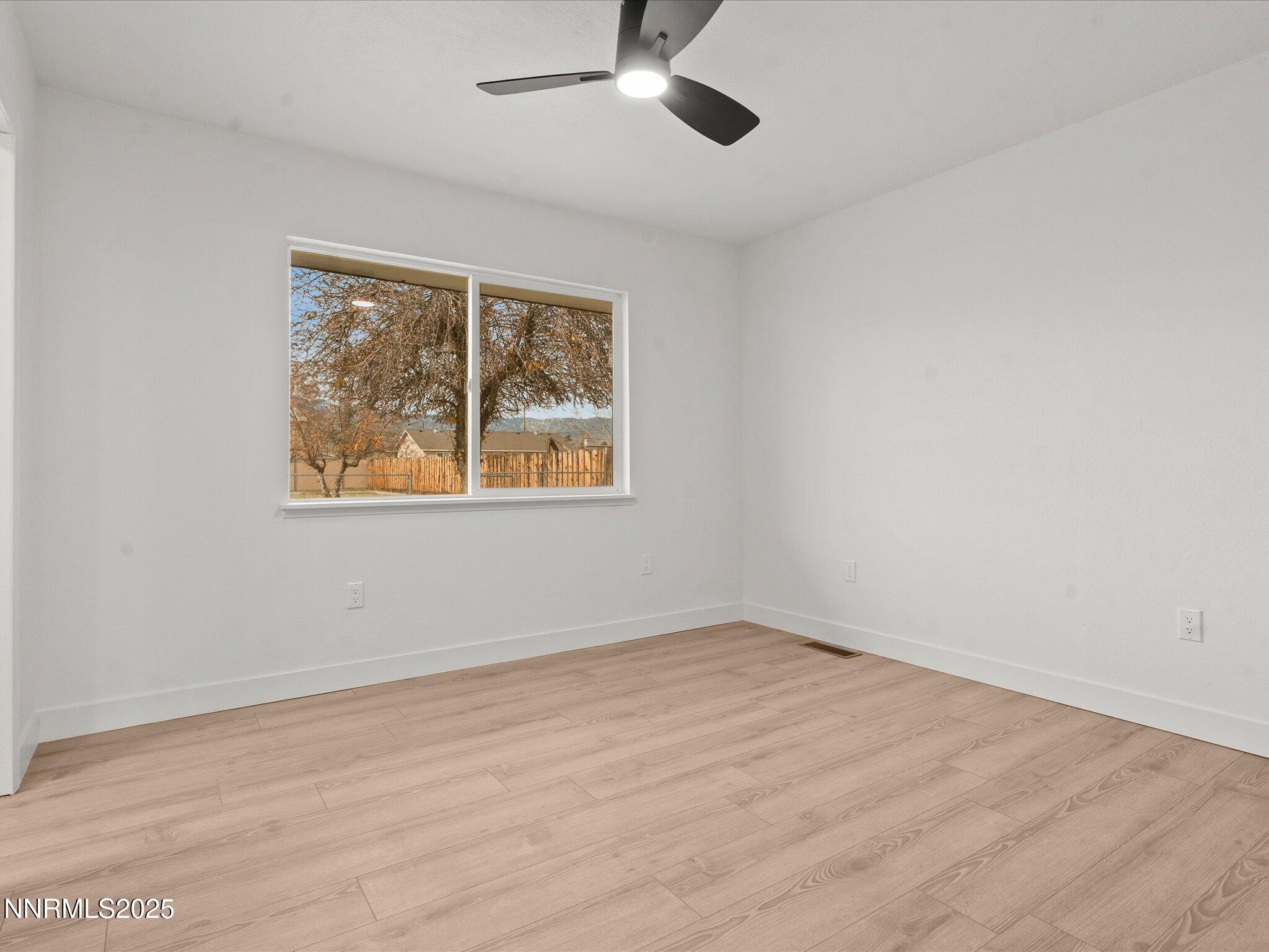 2940 Lukens Lane Carson City, NV 89706 - Photo 23 of 46 a view of an empty room with wooden floor and a window