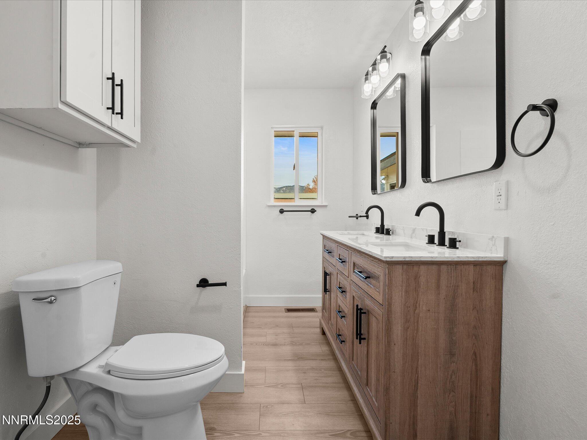 2940 Lukens Lane Carson City, NV 89706 - Photo 29 of 46 a spacious bathroom with a double vanity sink toilet and a mirror