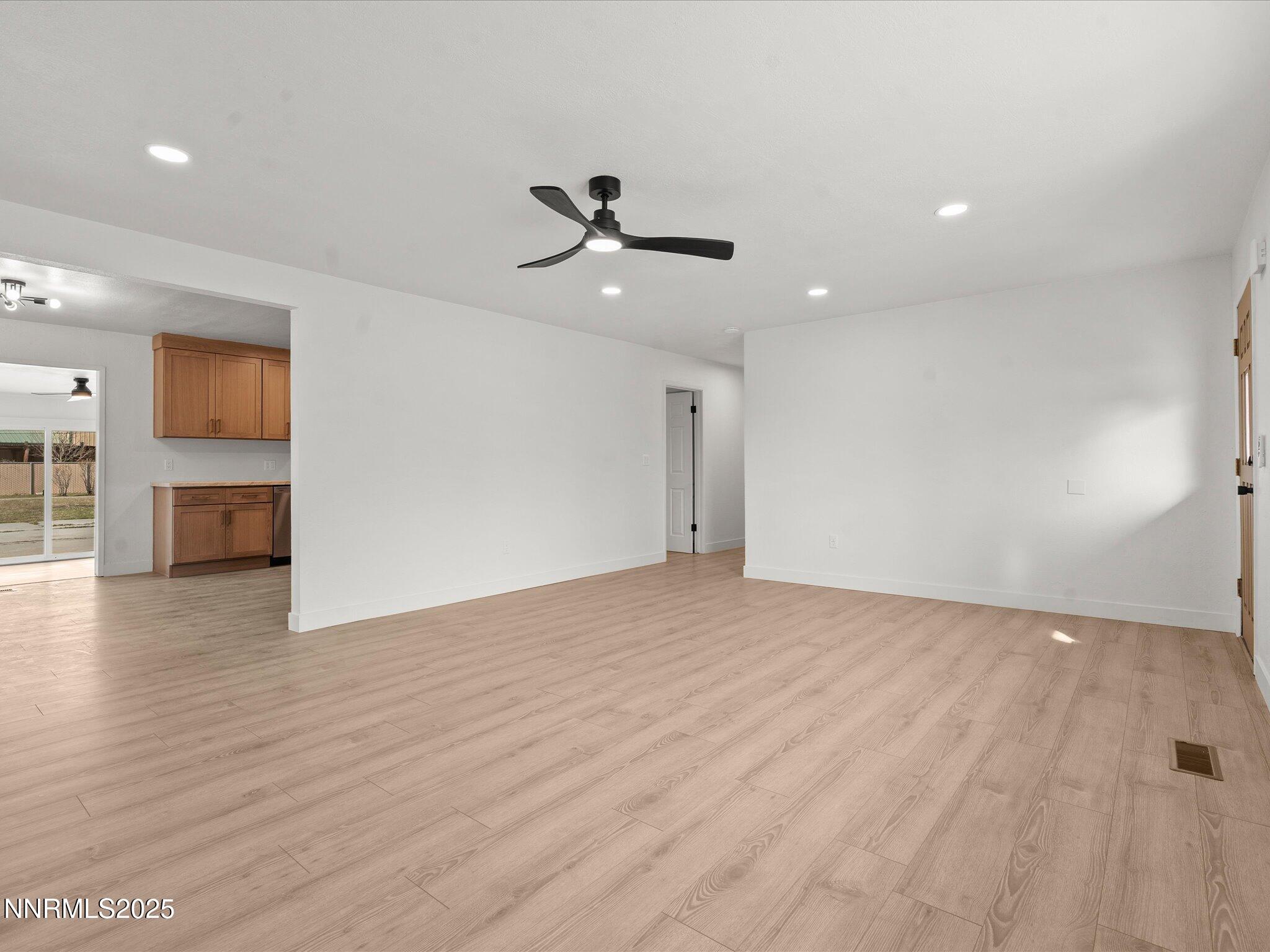 2940 Lukens Lane Carson City, NV 89706 - Photo 9 of 46 an empty room with wooden floor a ceiling fan and windows