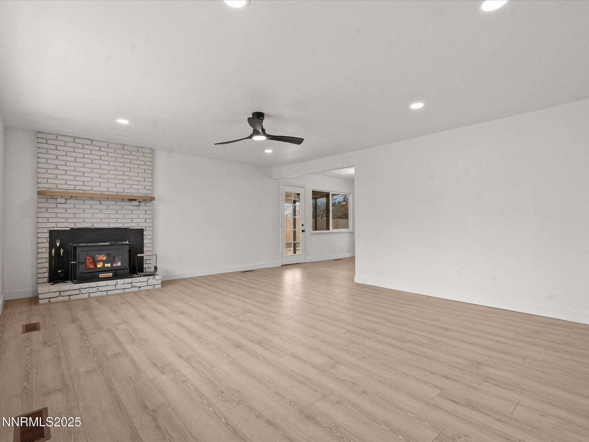 2940 Lukens Lane Carson City, NV 89706 - Photo 10 of 46 a view of an empty room with wooden floor fireplace and a window