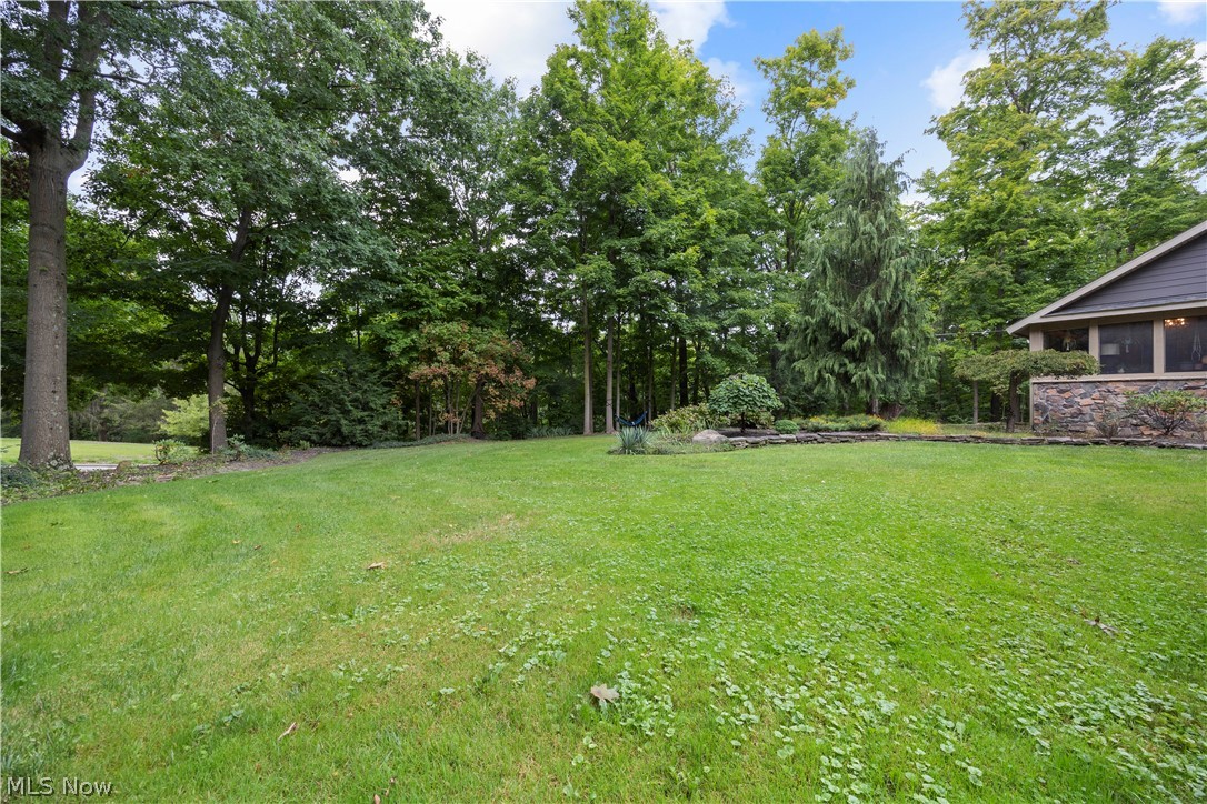 7587 Lewis Road Olmsted Falls, OH 44138 - Photo 46 of 50 Expansive lawn area with mature trees and a stone retaining wall