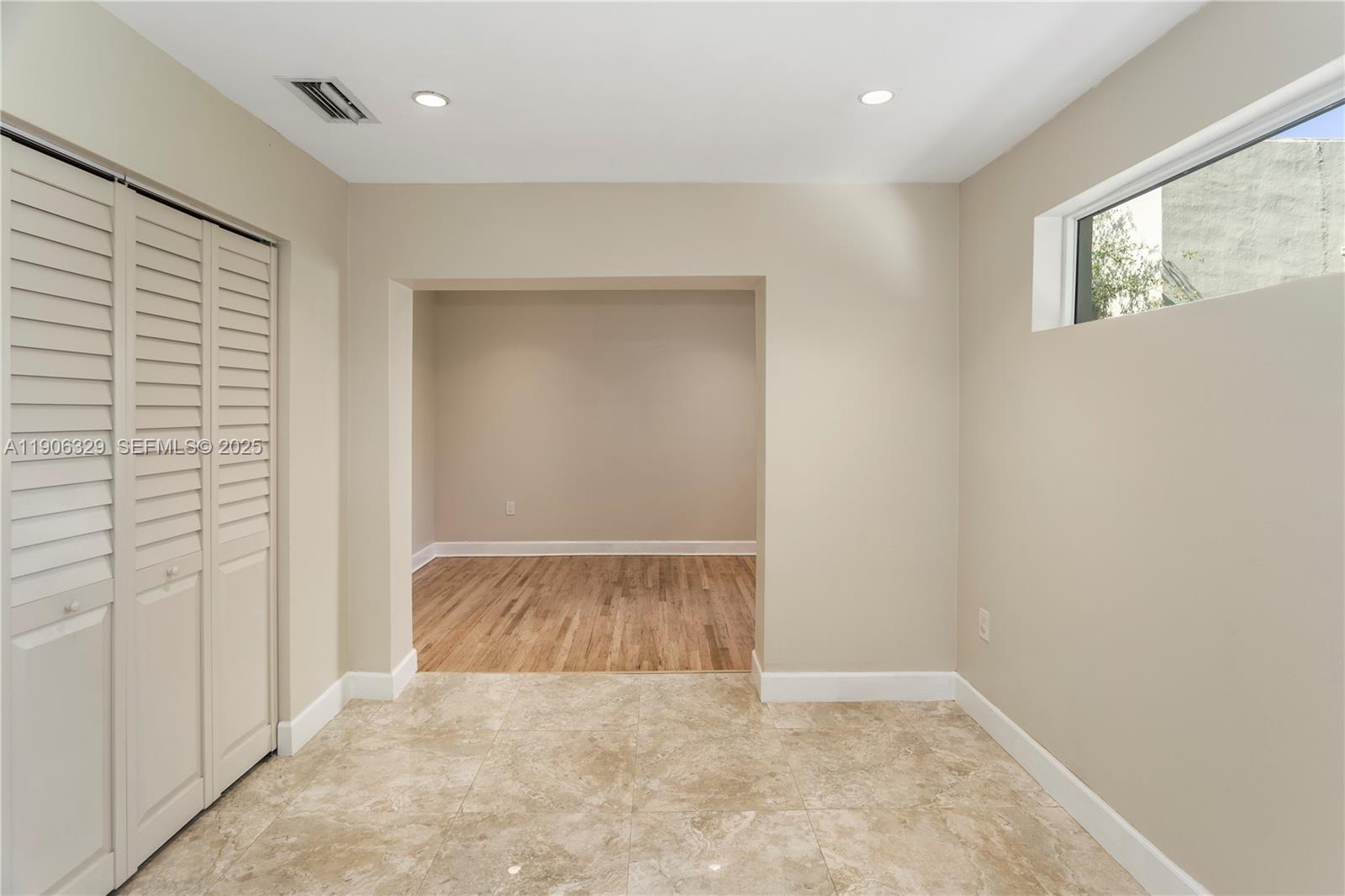 1776 Southwest 11th Terrace Miami, FL 33135 - Photo 11 of 25 an empty room with wooden floor and windows