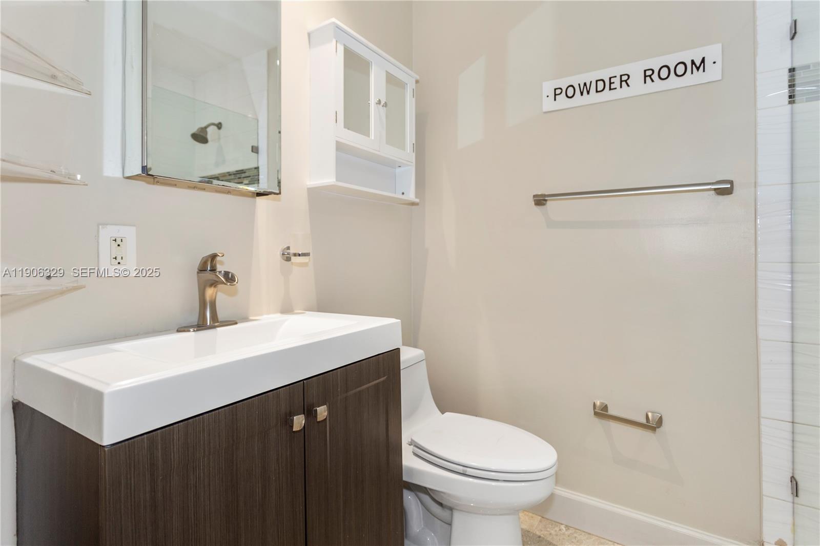 1776 Southwest 11th Terrace Miami, FL 33135 - Photo 14 of 25 a bathroom with a sink vanity mirror and toilet