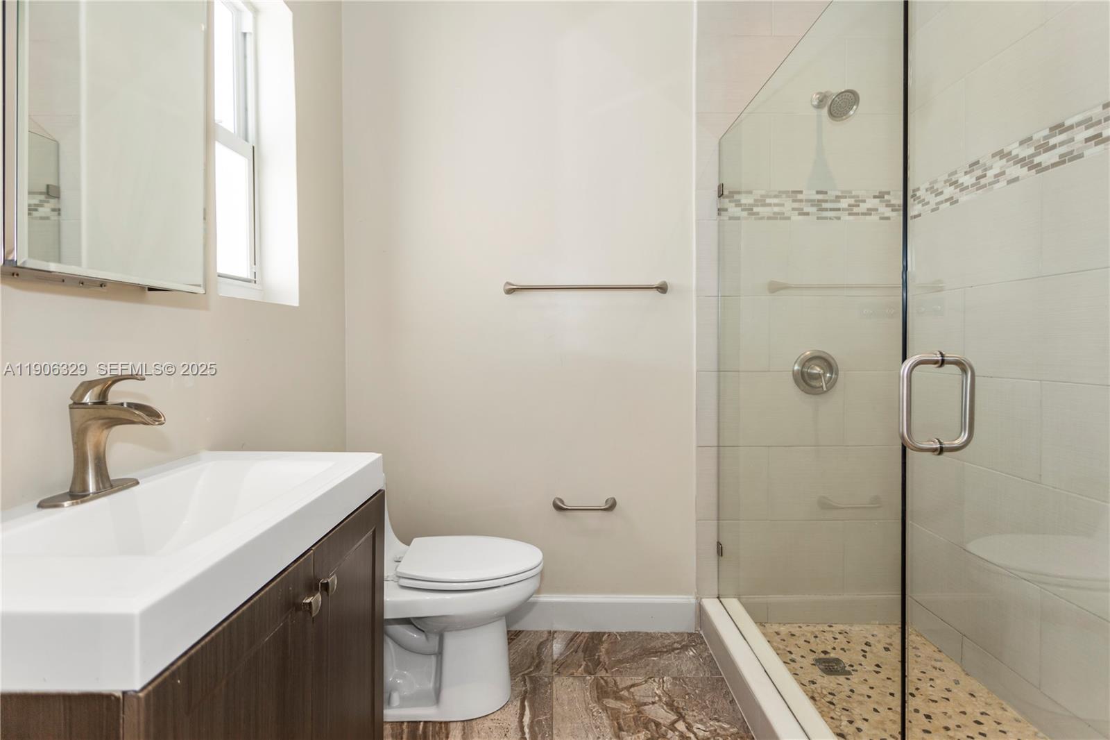 1776 Southwest 11th Terrace Miami, FL 33135 - Photo 17 of 25 a bathroom with a sink a toilet and shower