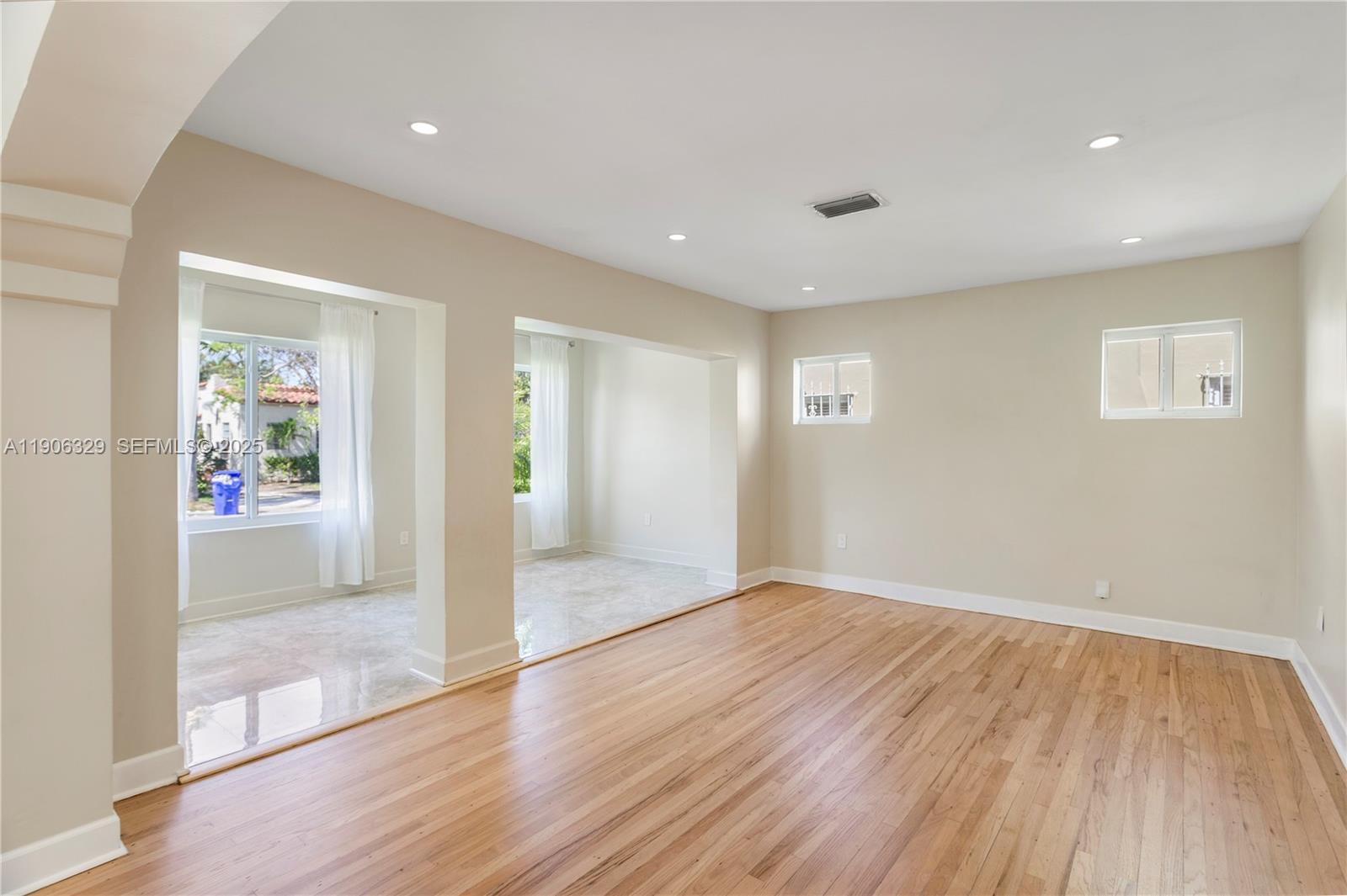1776 Southwest 11th Terrace Miami, FL 33135 - Photo 3 of 25 wooden floor in an empty room with a window