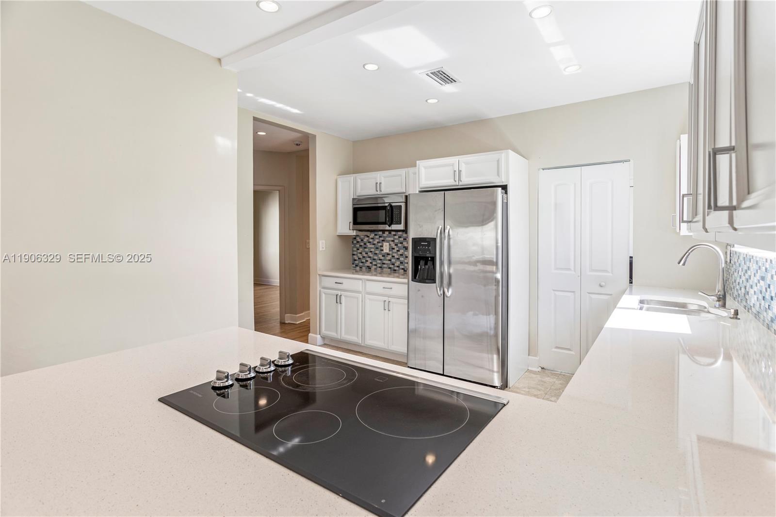 1776 Southwest 11th Terrace Miami, FL 33135 - Photo 7 of 25 a kitchen with a sink stove and refrigerator