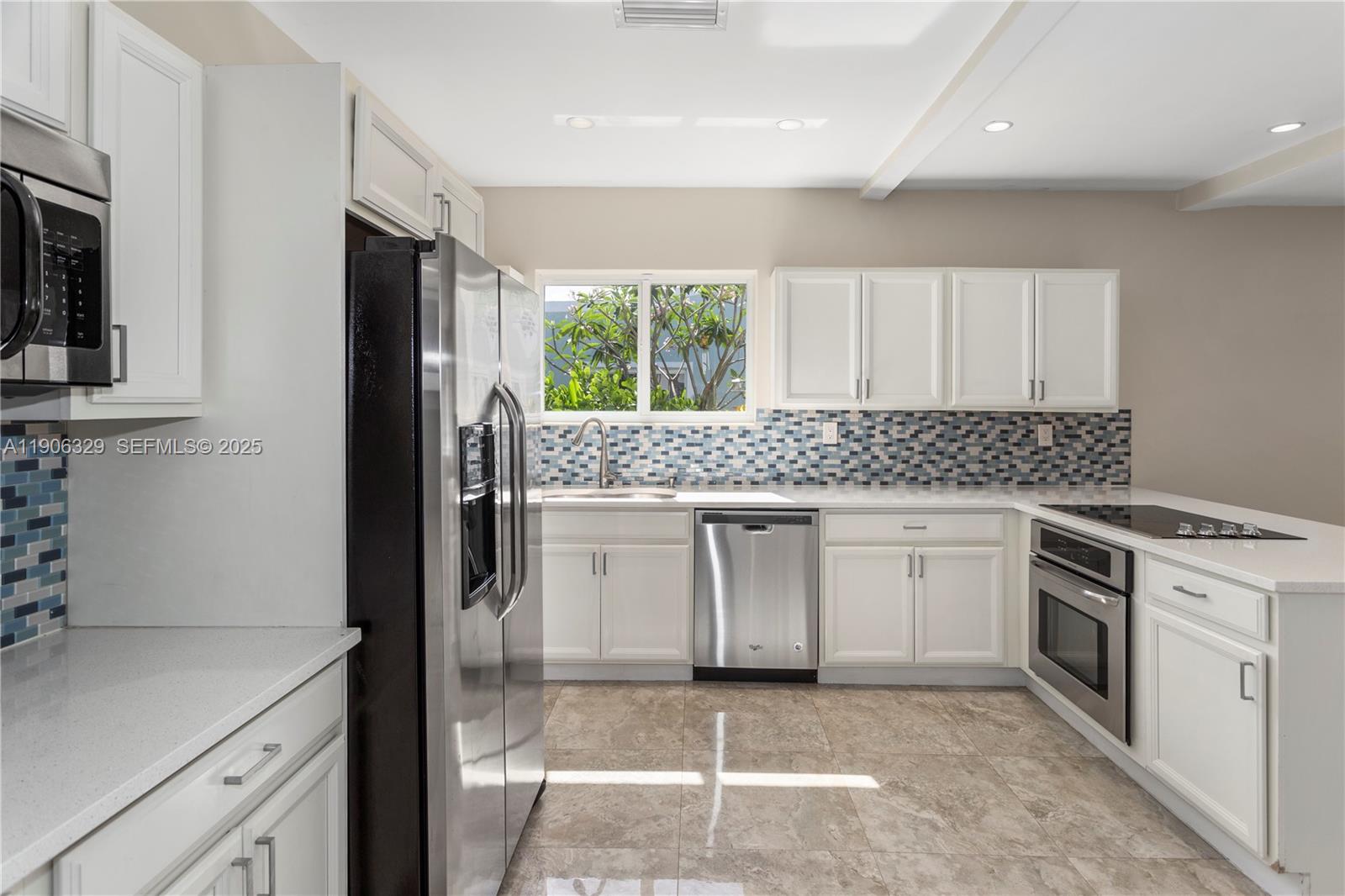 1776 Southwest 11th Terrace Miami, FL 33135 - Photo 8 of 25 a kitchen with a sink stove and refrigerator