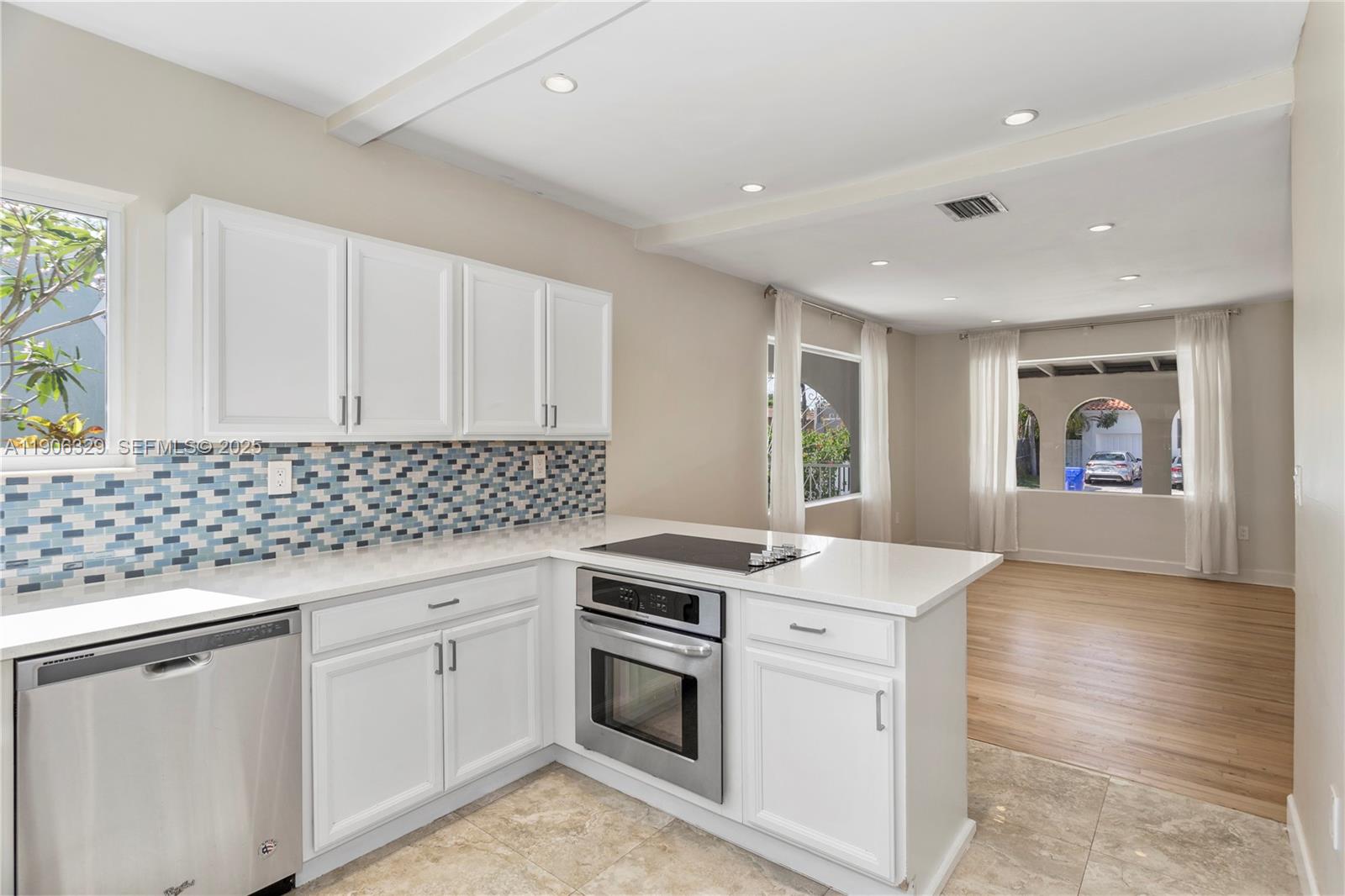 1776 Southwest 11th Terrace Miami, FL 33135 - Photo 10 of 25 a kitchen with granite countertop white cabinets and white appliances