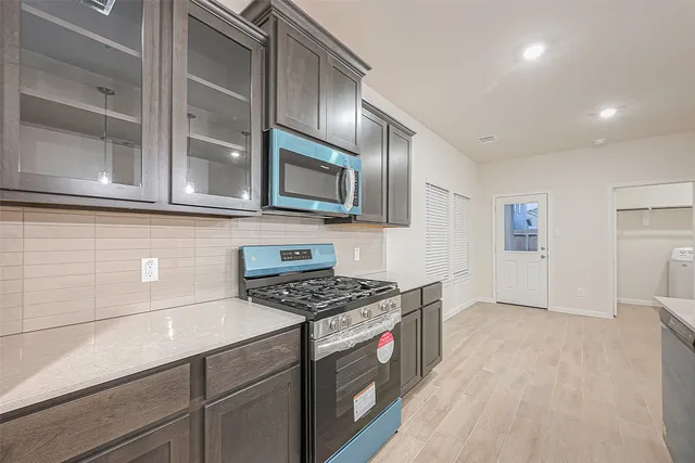 a kitchen with stainless steel appliances cabinets and a counter top space