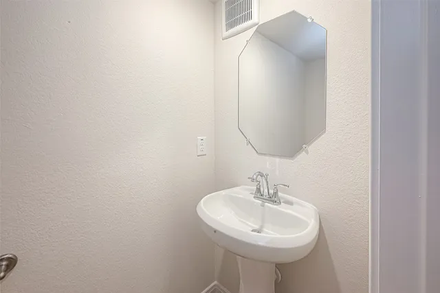 a bathroom with a sink a mirror and a toilet