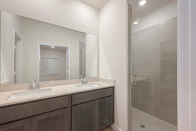 a bathroom with double sink and a mirror