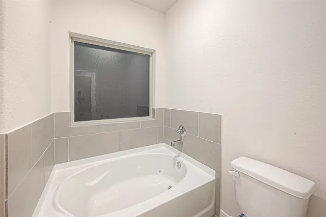 a bathroom with a bathtub and toilet