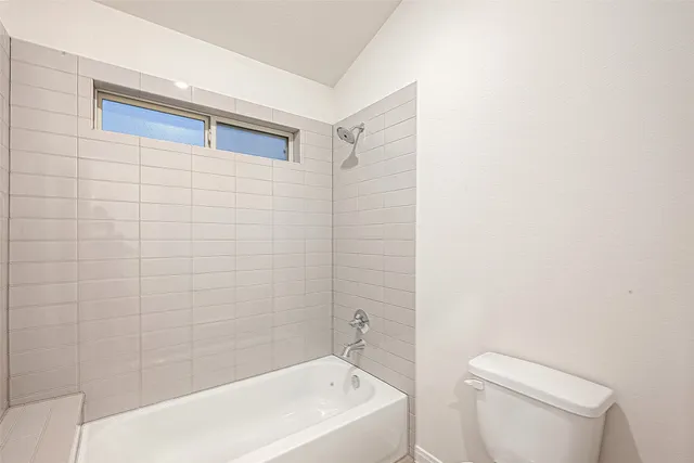 a bathroom with a bathtub and toilet