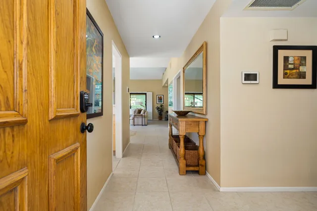 a dining room filled with furniture and a chandelier