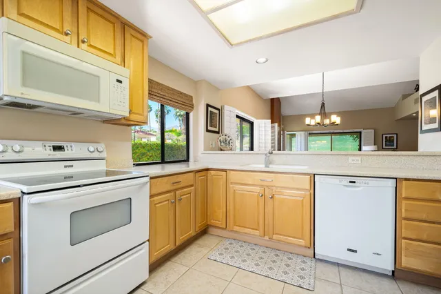 a living room with furniture fireplace and a large window