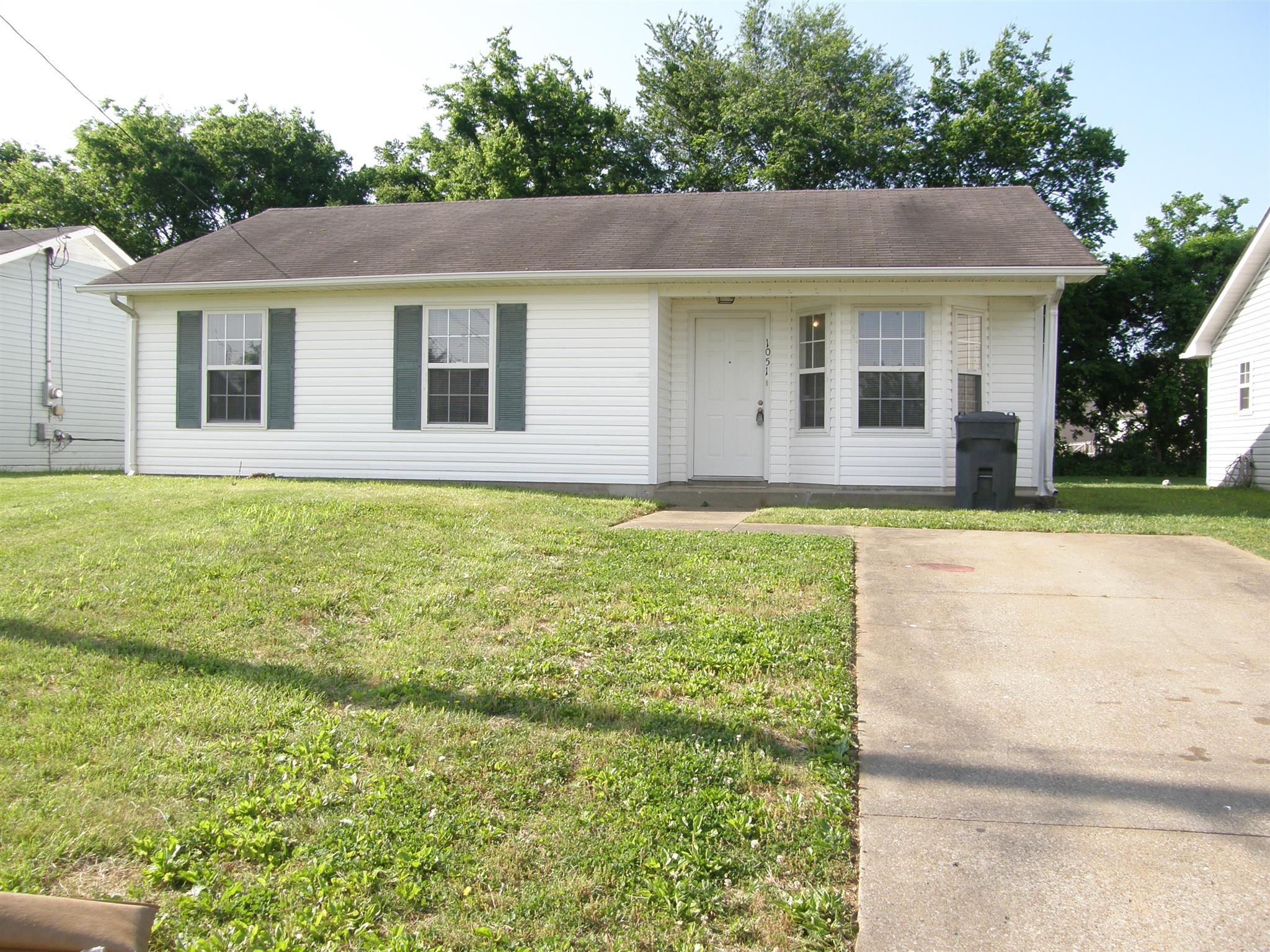 1051 Shadow Ridge Avenue Oak Grove, KY 42262 - Photo 1 of 20 a front view of a house with a garden and yard