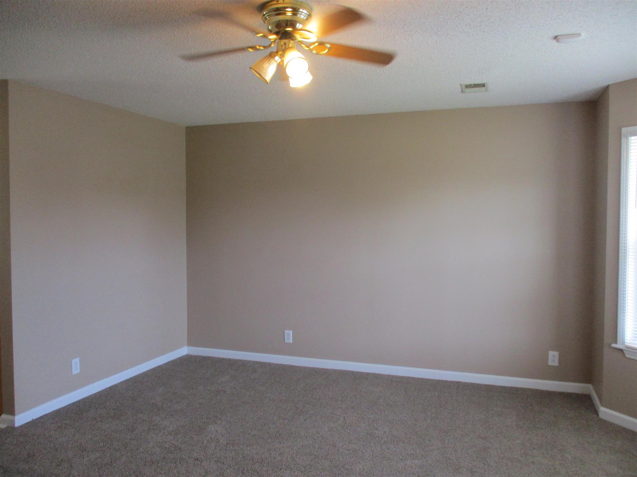 1051 Shadow Ridge Avenue Oak Grove, KY 42262 - Photo 5 of 20 an empty room with a chandelier fan and windows