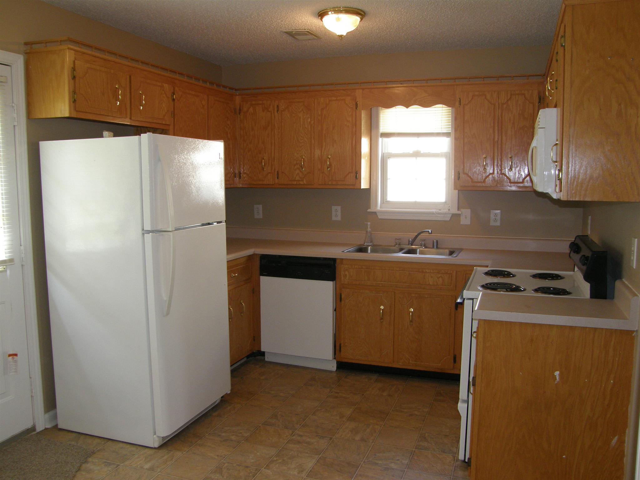 1051 Shadow Ridge Avenue Oak Grove, KY 42262 - Photo 7 of 20 a kitchen with a refrigerator sink and stove