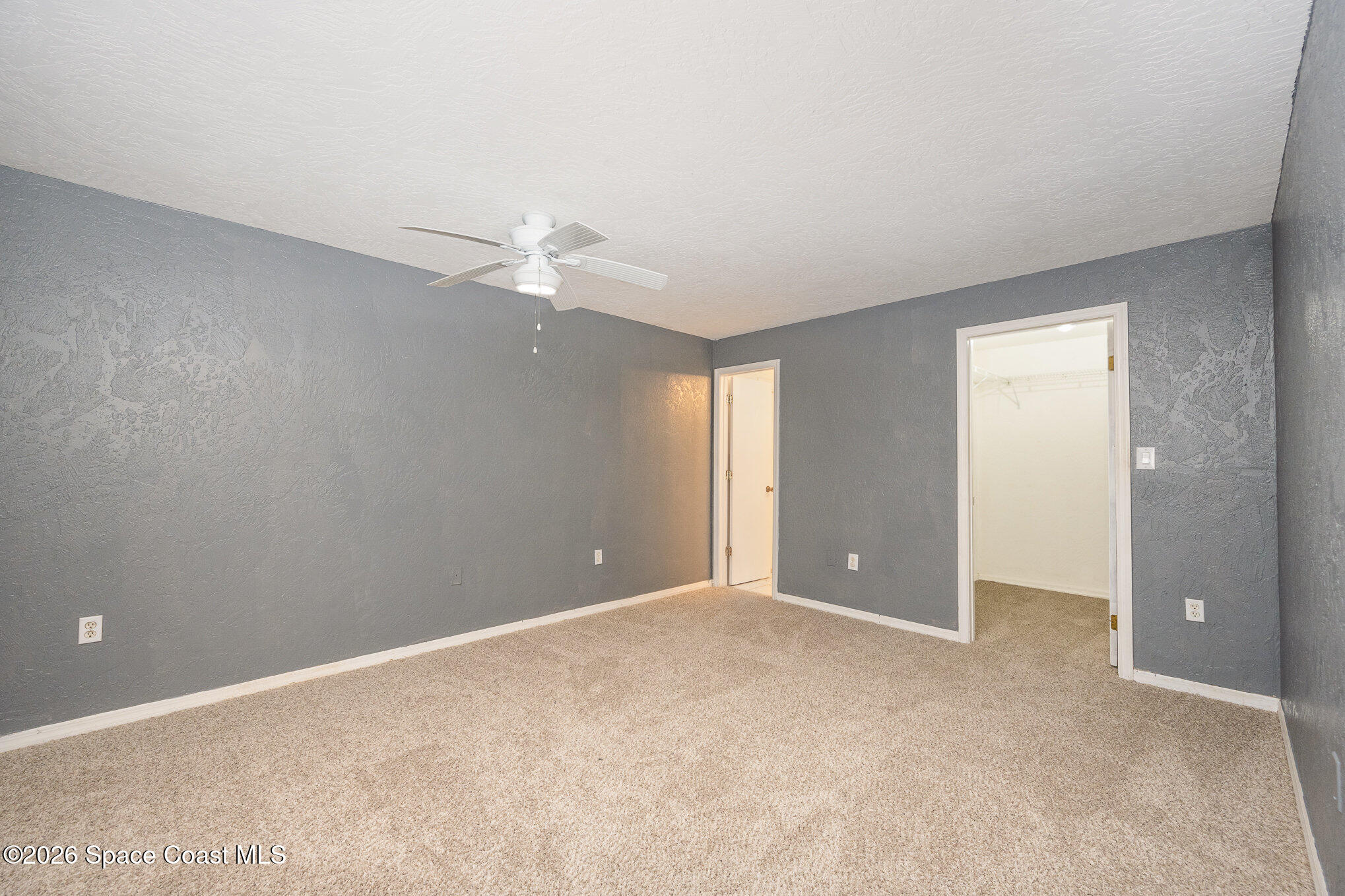 696 Las Palmas Way Melbourne, FL 32940 - Photo 13 of 21 a view of an empty room with a ceiling fan