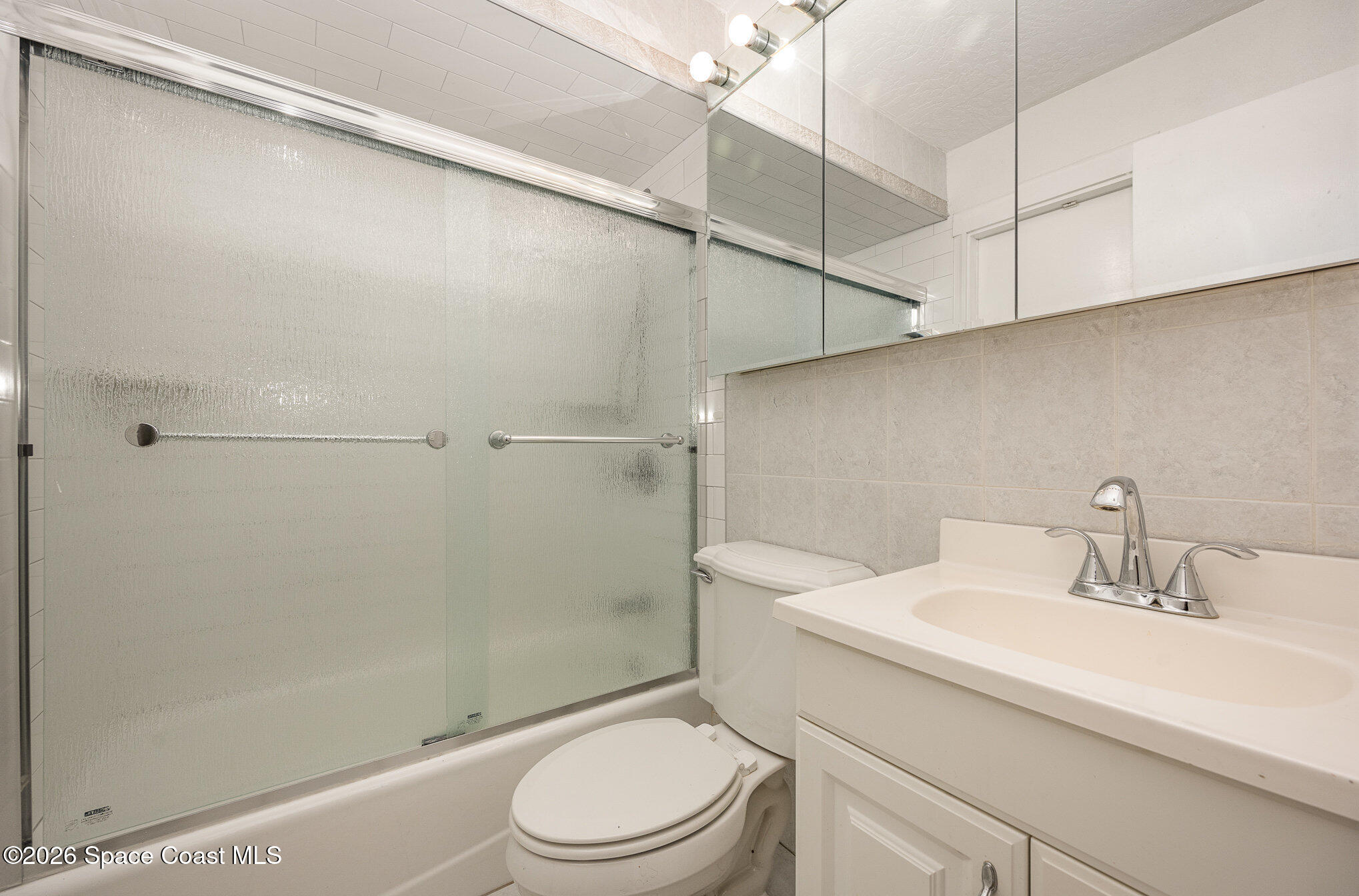 696 Las Palmas Way Melbourne, FL 32940 - Photo 14 of 21 a bathroom with a sink a toilet and shower