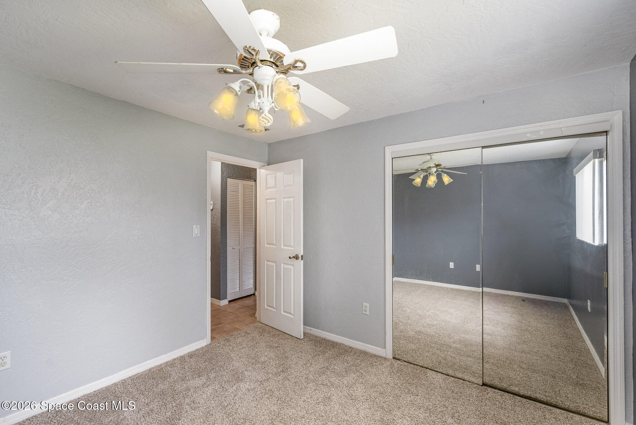 696 Las Palmas Way Melbourne, FL 32940 - Photo 16 of 21 a view of an empty room with a fan