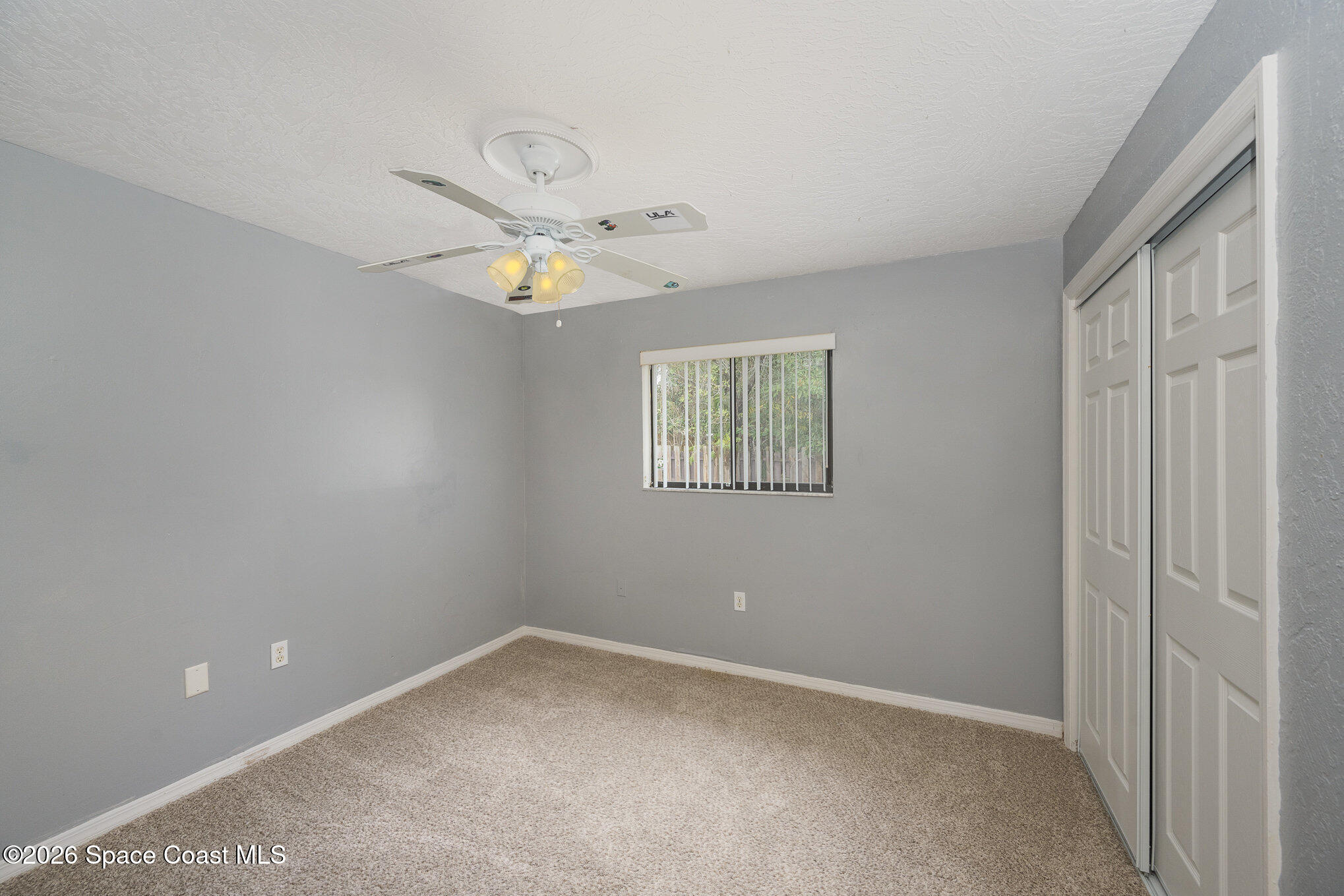 696 Las Palmas Way Melbourne, FL 32940 - Photo 17 of 21 an empty room with a window and a fan