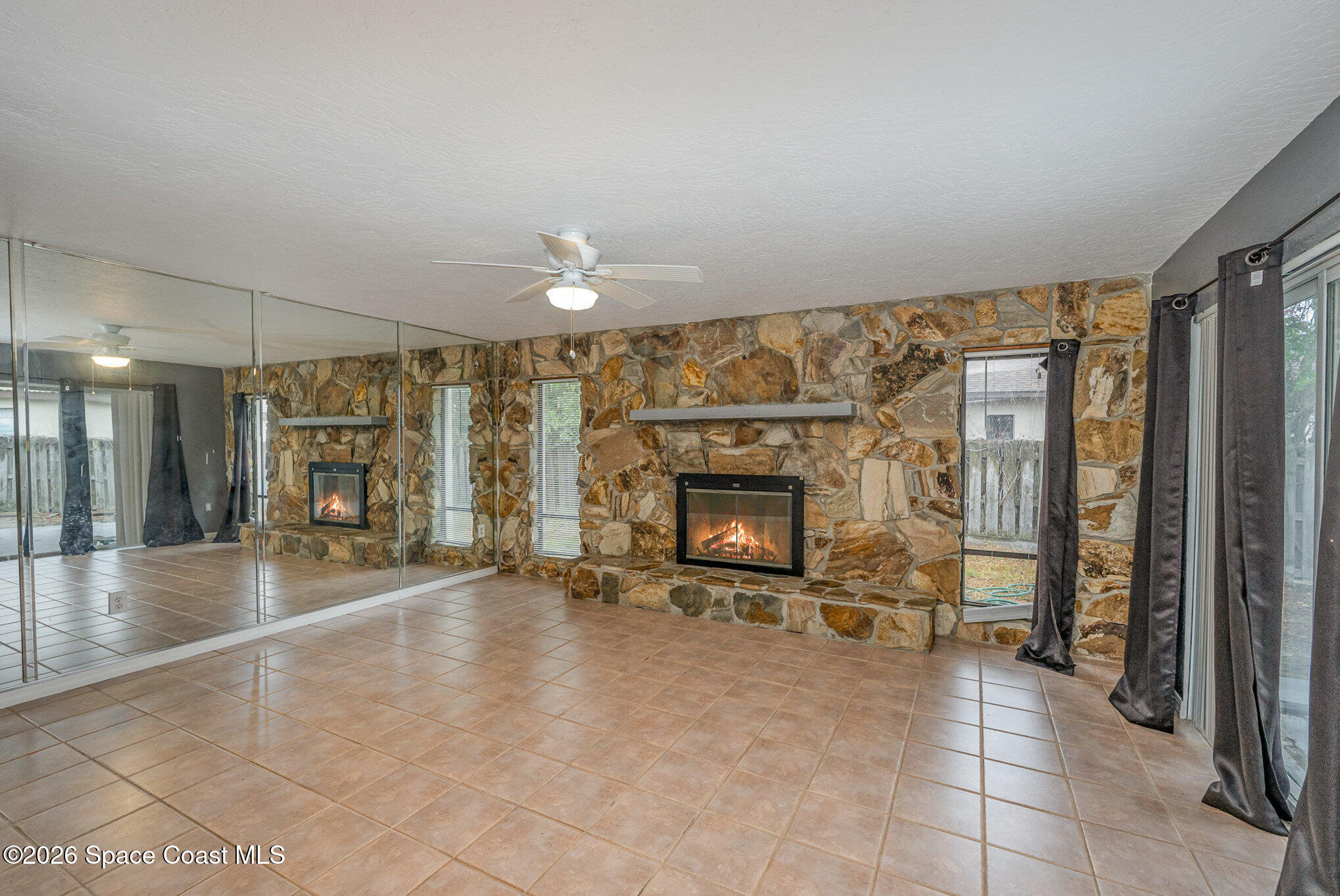696 Las Palmas Way Melbourne, FL 32940 - Photo 2 of 21 a living room with furniture and a fireplace