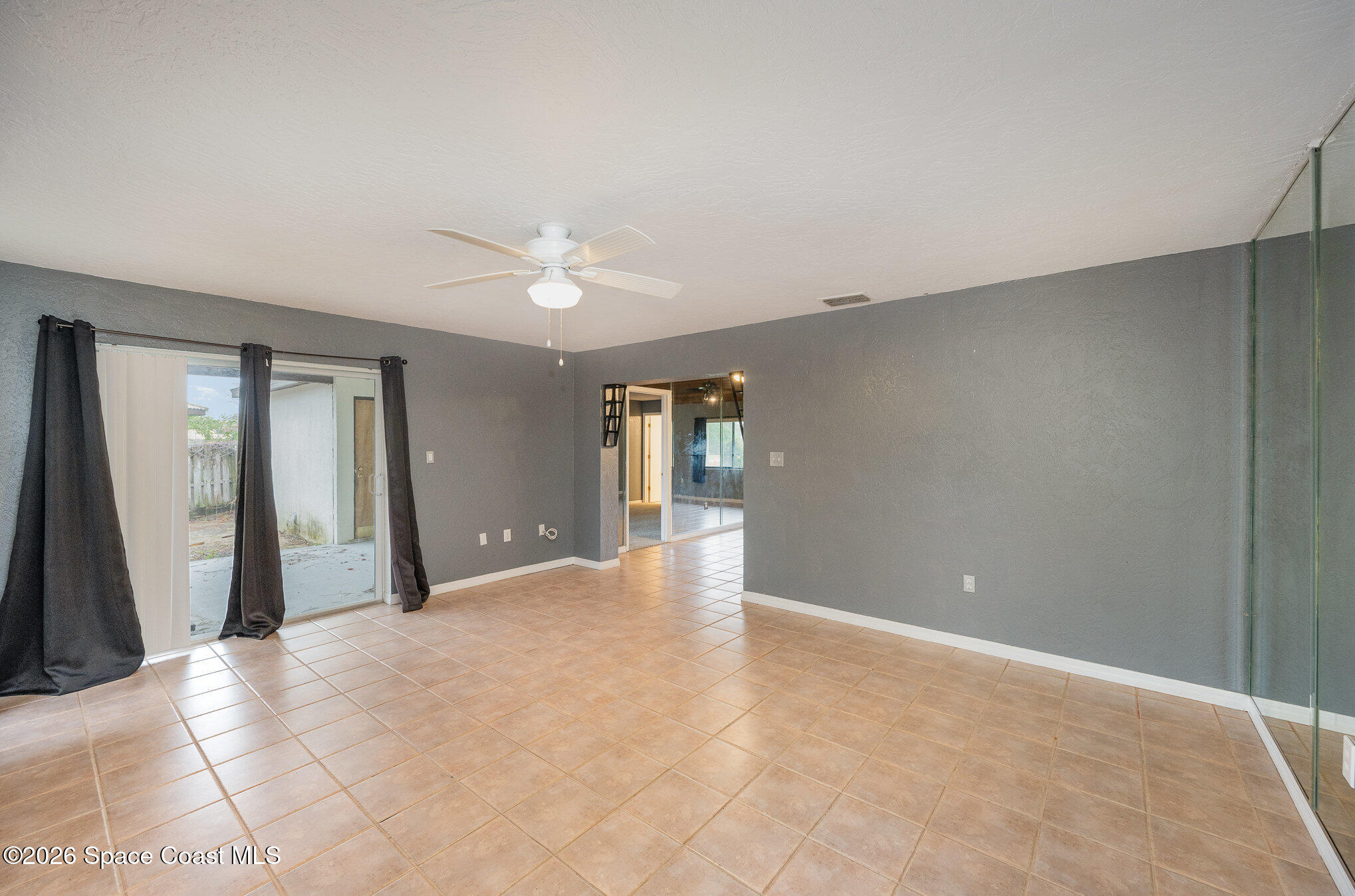 696 Las Palmas Way Melbourne, FL 32940 - Photo 4 of 21 a view of an empty room with closet and wooden floor