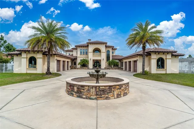 a front view of a house with yard and garage