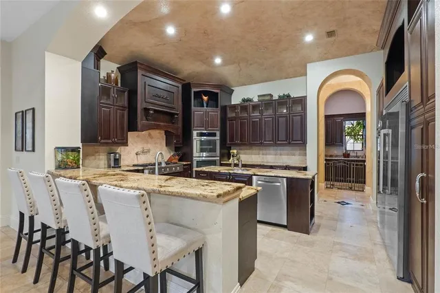 a kitchen with granite countertop a stove and a sink