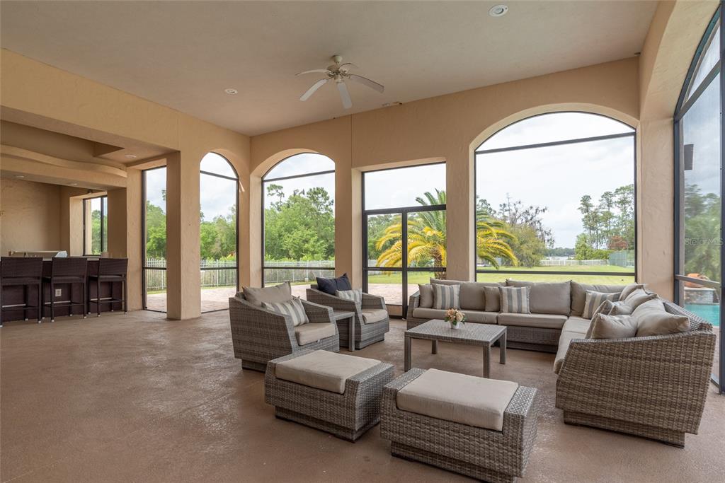 5251 Carson Street St. Cloud, FL 34771 - Photo 27 of 60 a living room with furniture and floor to ceiling windows