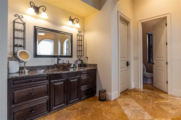a bathroom with a toilet a sink and a mirror