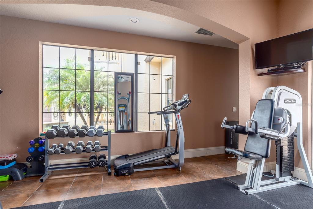 5251 Carson Street St. Cloud, FL 34771 - Photo 37 of 60 a room with gym equipment and a large window