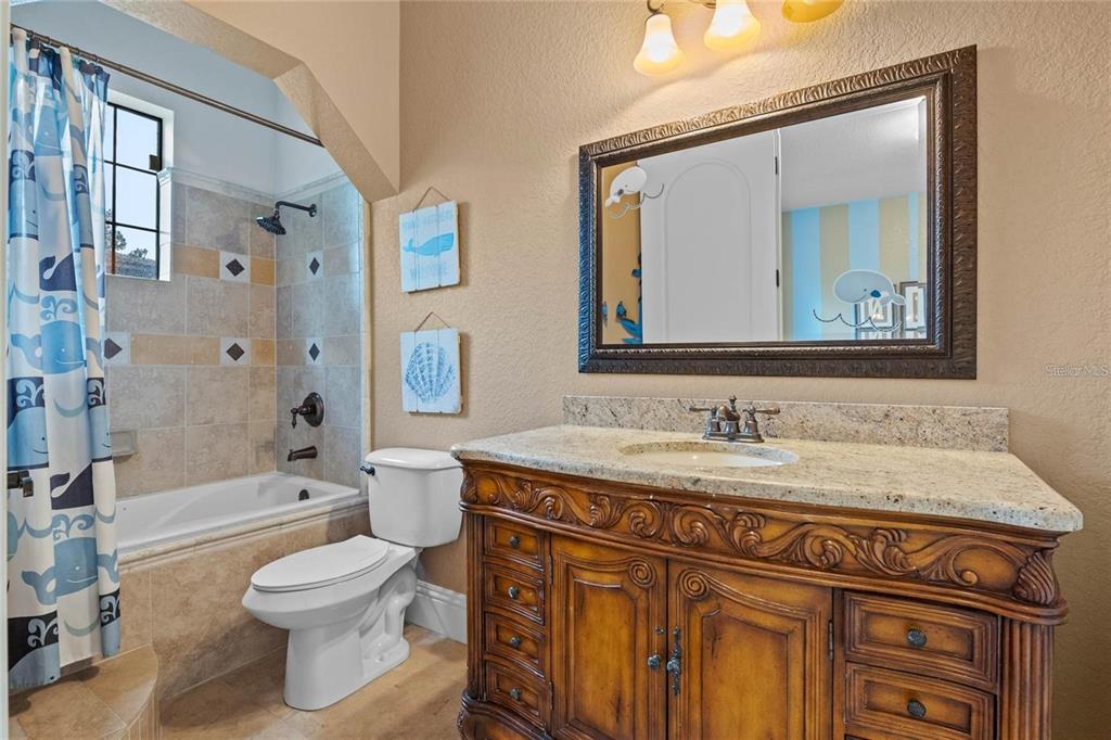 5251 Carson Street St. Cloud, FL 34771 - Photo 39 of 60 a bathroom with a granite countertop toilet a sink and a mirror