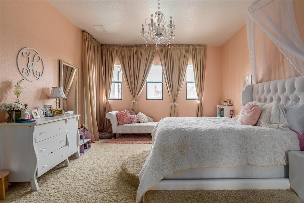 5251 Carson Street St. Cloud, FL 34771 - Photo 44 of 60 a spacious bedroom with a bed and window