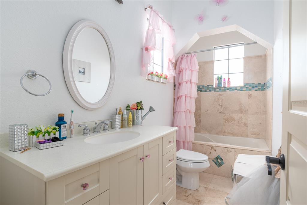 5251 Carson Street St. Cloud, FL 34771 - Photo 46 of 60 a bathroom with a granite countertop sink mirror vanity and toilet