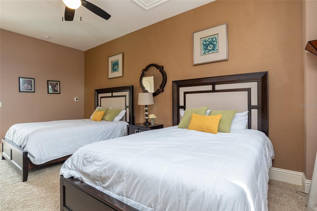 5251 Carson Street St. Cloud, FL 34771 - Photo 49 of 60 a bedroom with two beds and a chandelier