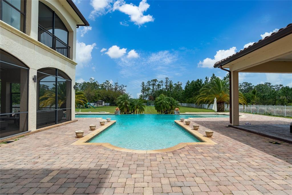 5251 Carson Street St. Cloud, FL 34771 - Photo 54 of 60 a view of a house with backyard porch and patio