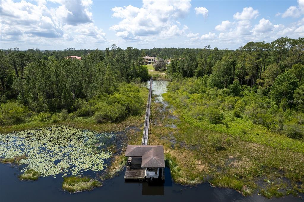 5251 Carson Street St. Cloud, FL 34771 - Photo 59 of 60 a room with a bench and trees