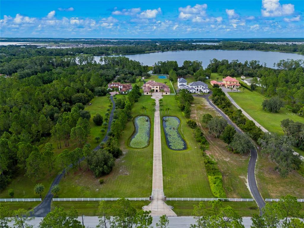 5251 Carson Street St. Cloud, FL 34771 - Photo 9 of 60 an aerial view of lake and residential houses with outdoor space