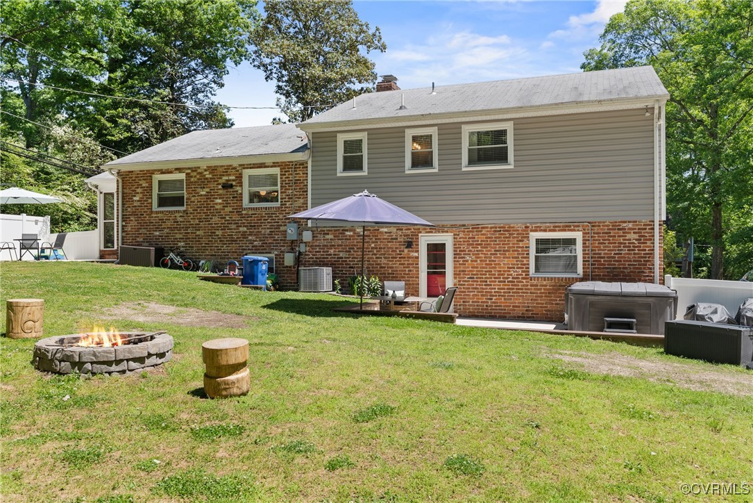 5018 Grassmere Road Richmond, VA 23234 - Photo 32 of 34 Back of house featuring a fire pit, brick siding,