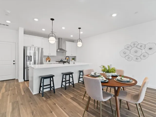 a large kitchen with sink a counter top space and living room view